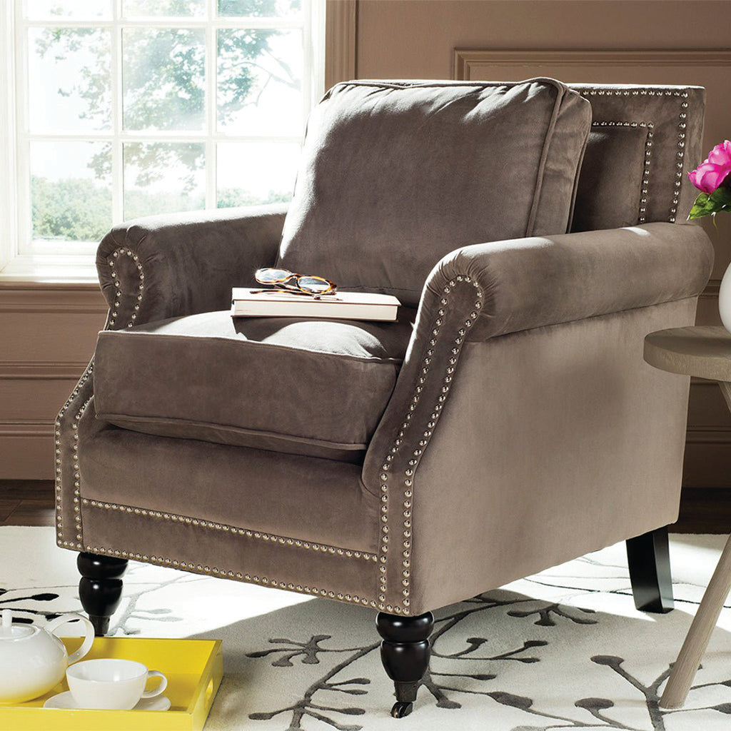 Upholstered recliner on area rug with accent table