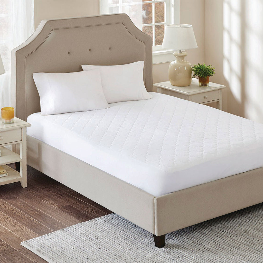 Mattress protector on upholstered bed