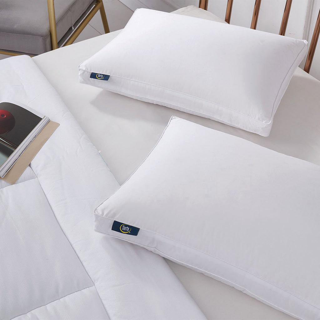 Different sized pillows on a bed