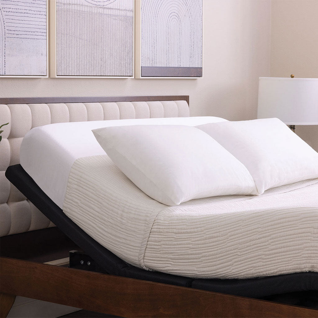 Adjustable base with white sheets and pillows