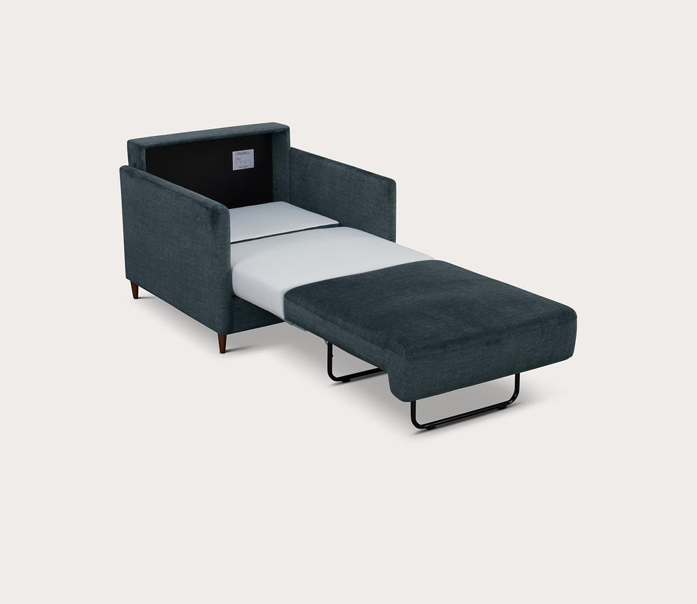 Emerald chair with white mattress on a light gray background