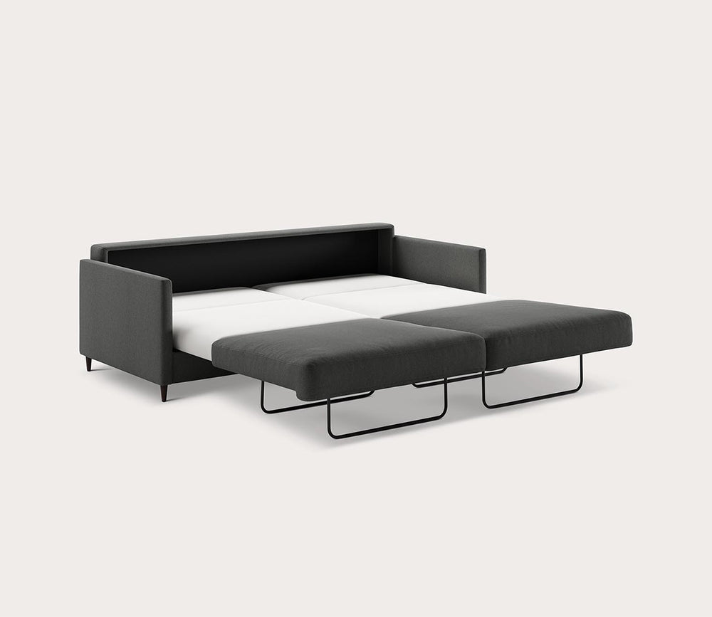Black sofa bed with ottoman on a white background