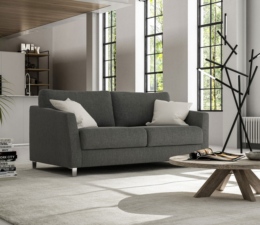 Gray sofa in a modern living room with a coffee table and decorative items.