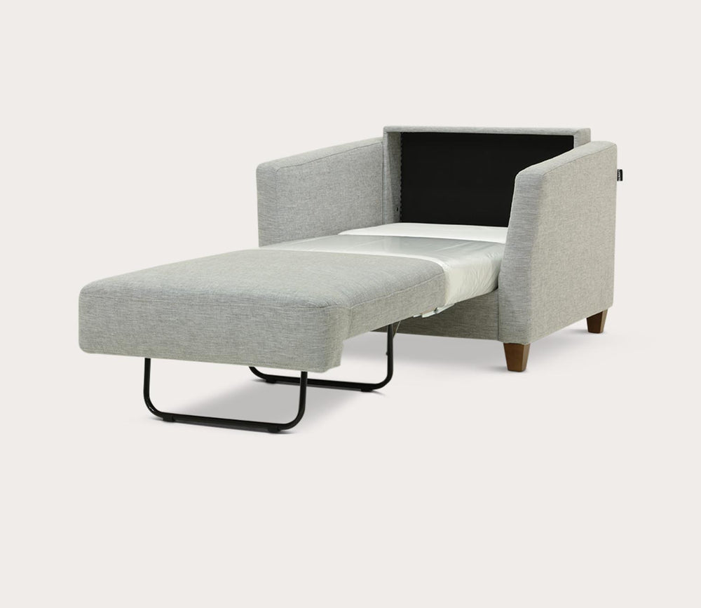 Gray sofa bed with a white mattress on a light gray background