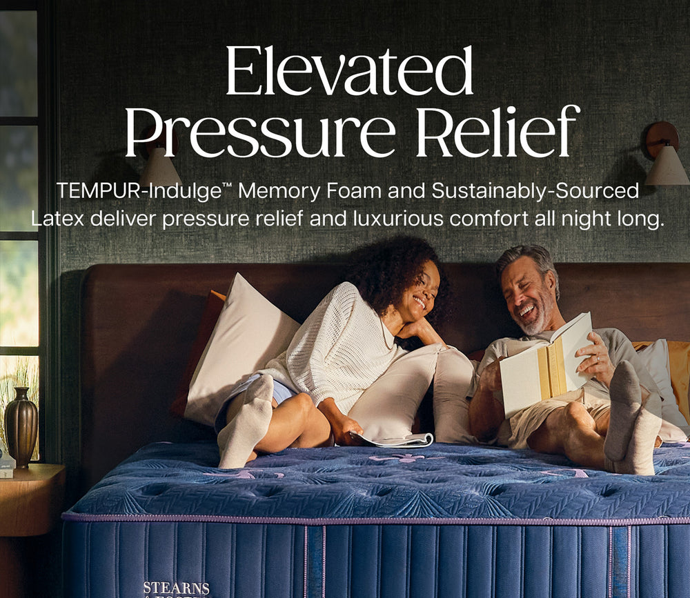 Man and woman resting on Stearns & Foster Legacy Ultra Firm II Mattress featuring Tempur-Indulge memory foam