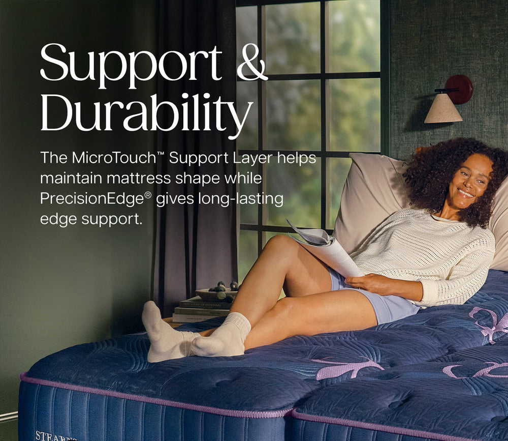 A woman reclines on a mattress in a bedroom setting, with large text on the left reading 'Support & Durability' and descriptive copy about the MicroTouch Support Layer and PrecisionEdge edge support.