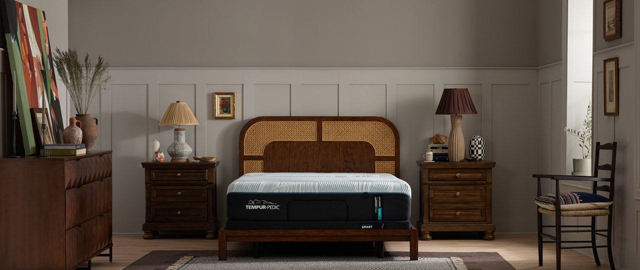 Bedroom with wooden bed, nightstands, and lamps.