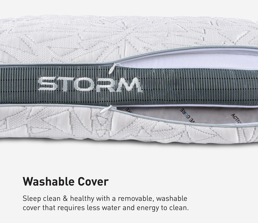Close-up of a Storm pillow cover with a gray zipper and the word STORM across it, plus text below reading 'Washable Cover' with a descriptive marketing note.