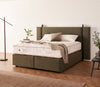Vispring Masterpiece Superb Mattress displayed on a matching upholstered divan base in a modern bedroom with layered bedding and neutral décor.