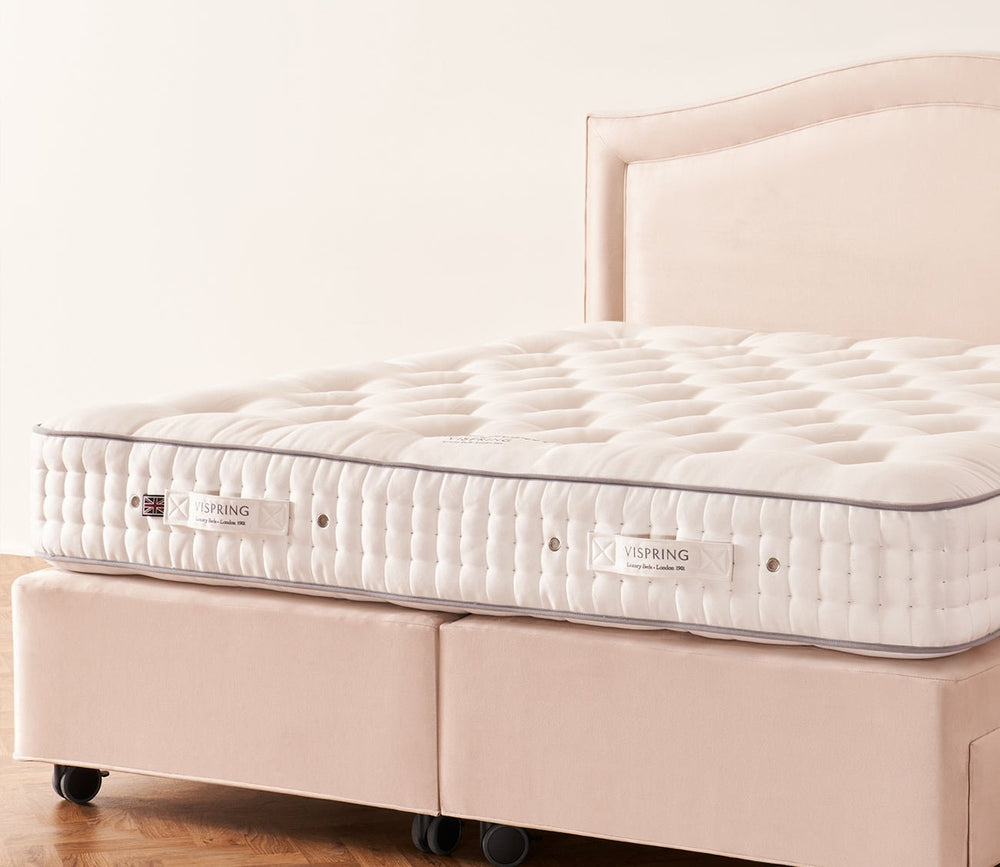 Vispring Regal Superb Mattress on an upholstered divan base with a hand-tufted sleep surface.