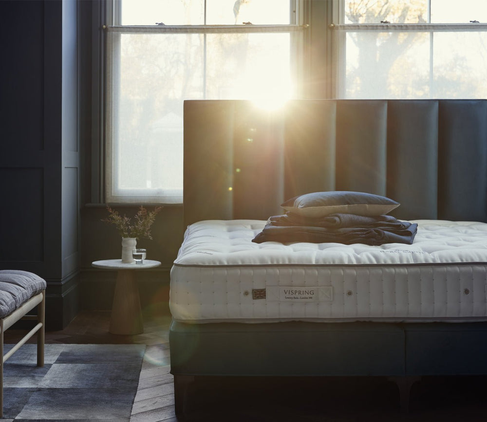 Vispring Regal Superb Plush Mattress in a bedroom with a hand-tufted sleep surface and layered bedding.