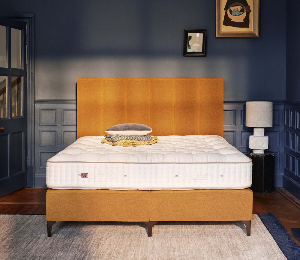Vispring Signatory Superb Mattresson an upholstered divan base in a contemporary bedroom.